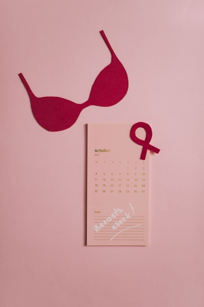 Pink bra and ribbon with October calendar for Breast Cancer Awareness.